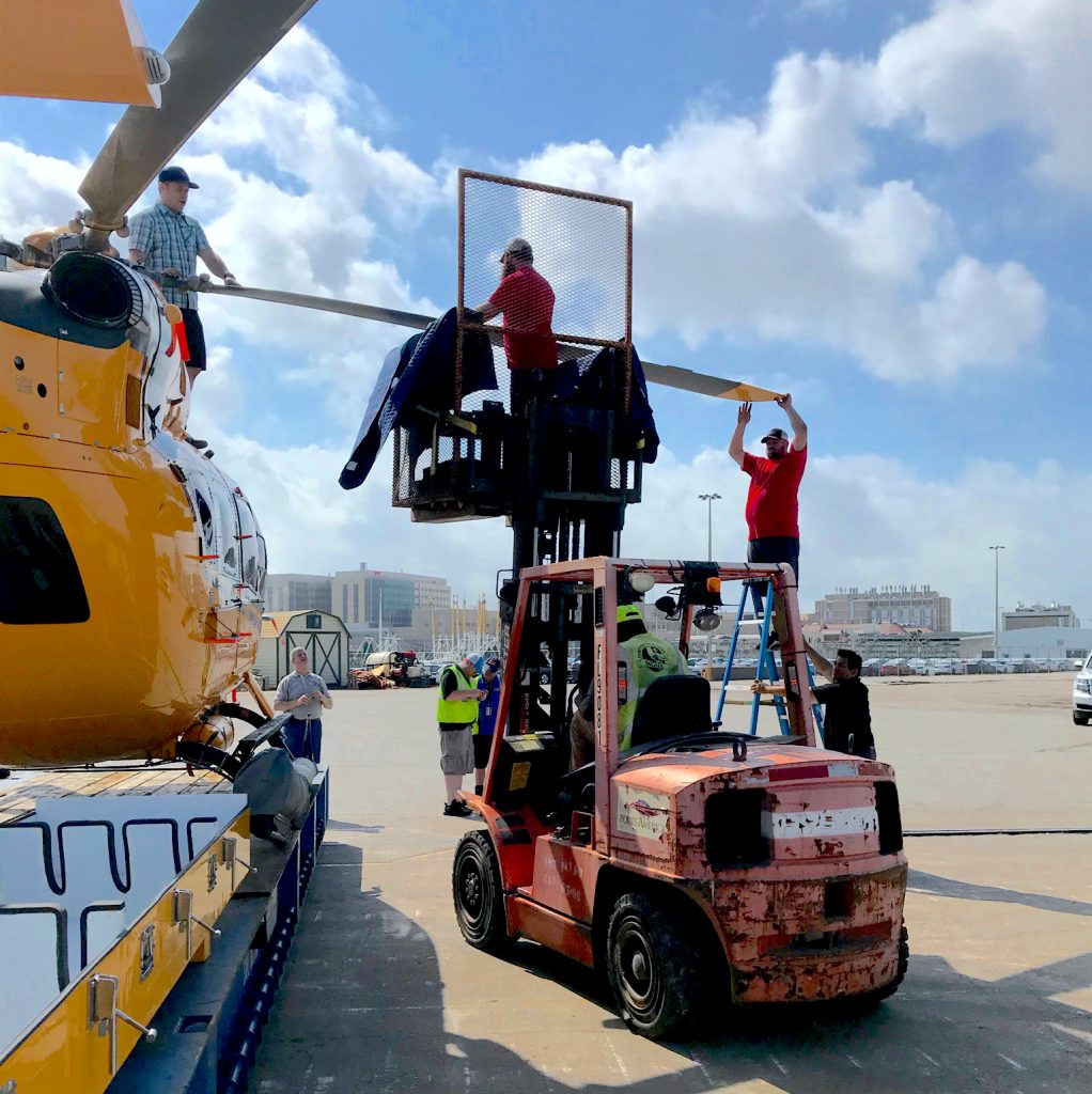Fork Lift assisting technician in removing the blade on an H145 airbus helicopter.